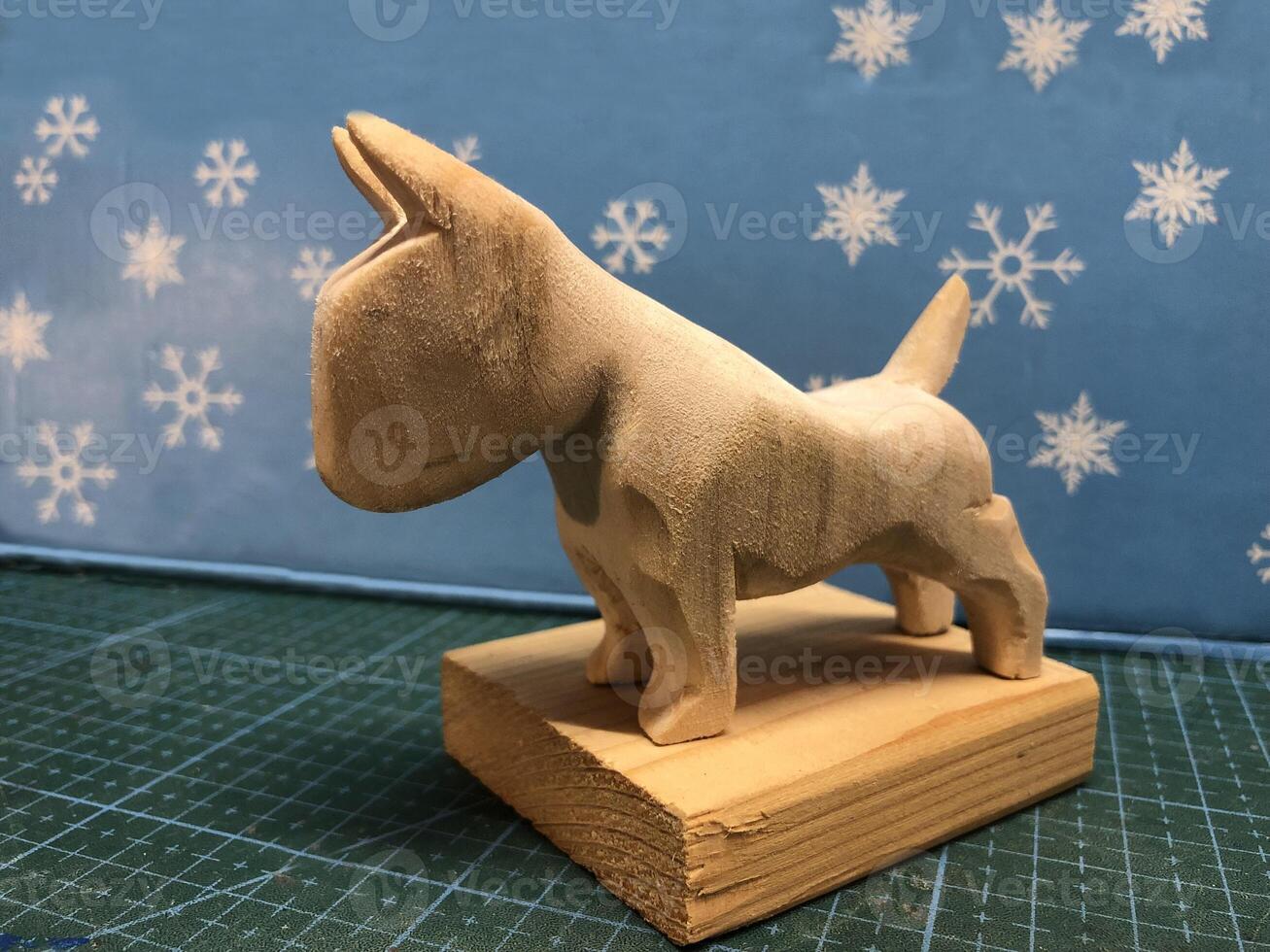 small wooden figurine of a bull terrier stand photo