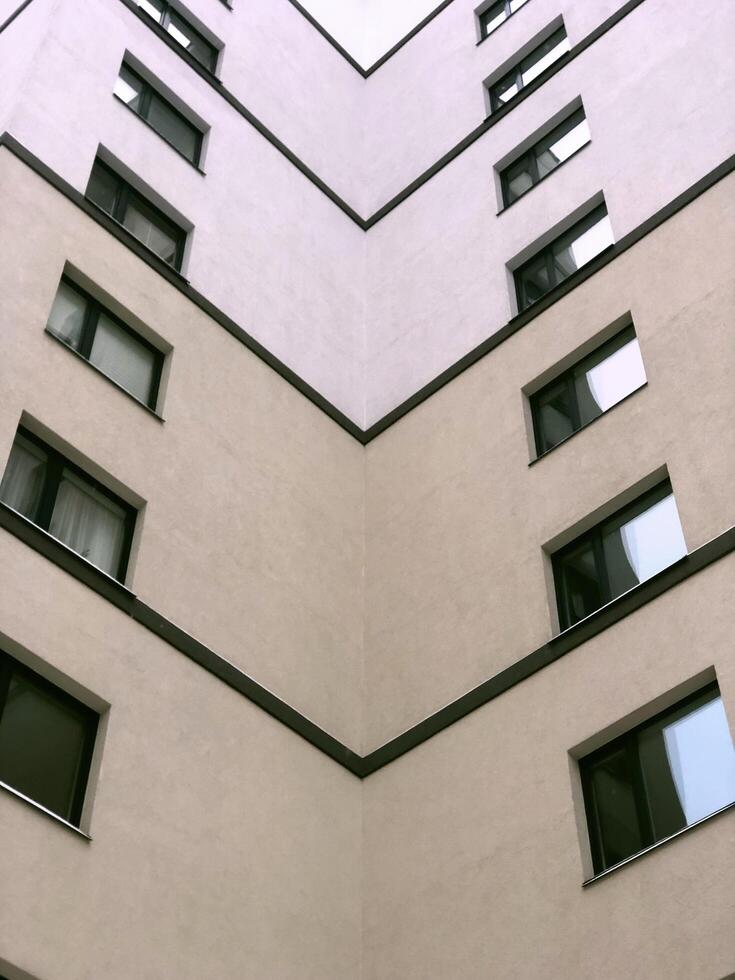 internal corner of the building, wall with windows, dead end, multi-story building modern architecture, low angle view photo
