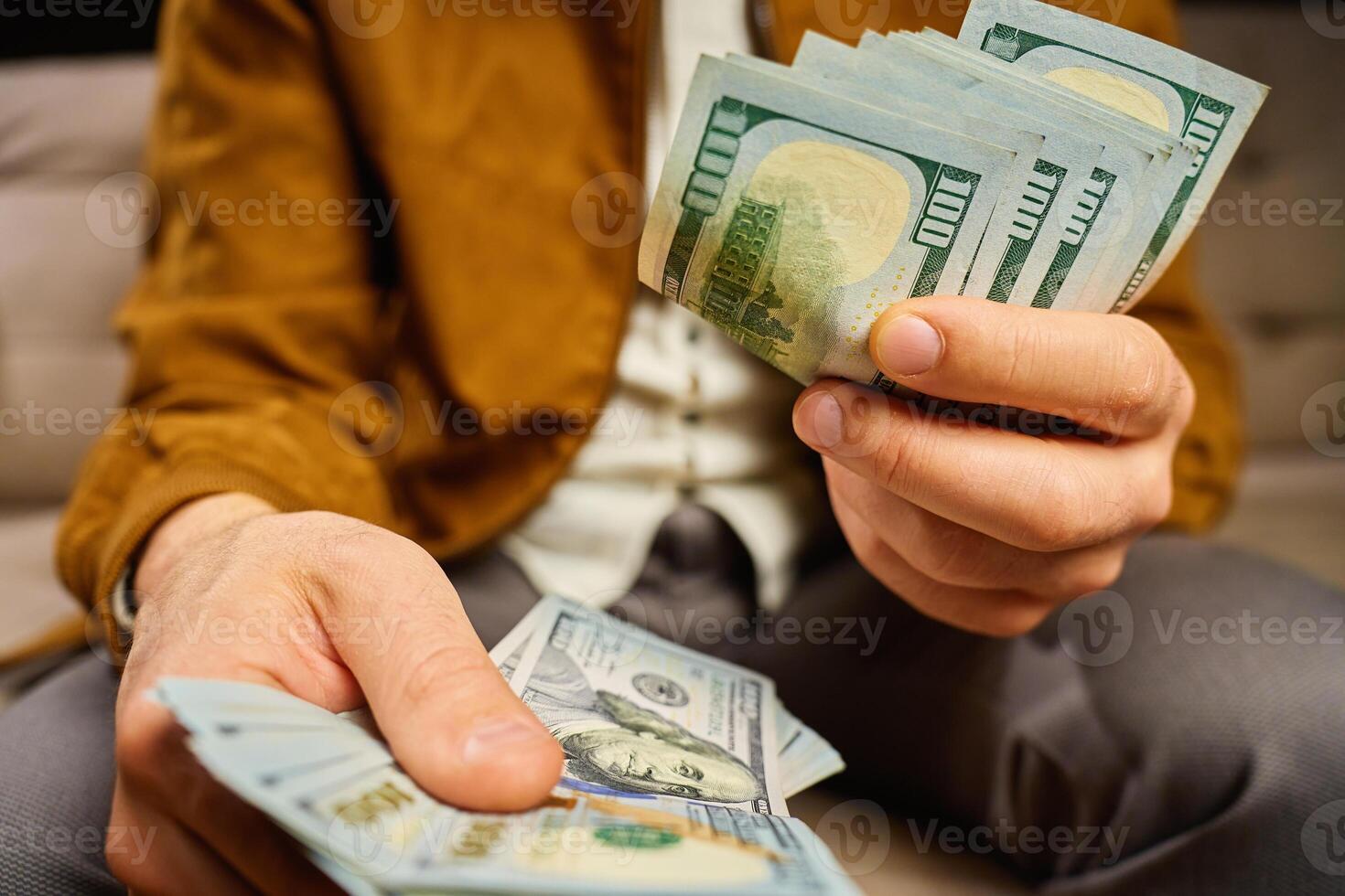 Close-up of hands counting US dollar bills at home photo