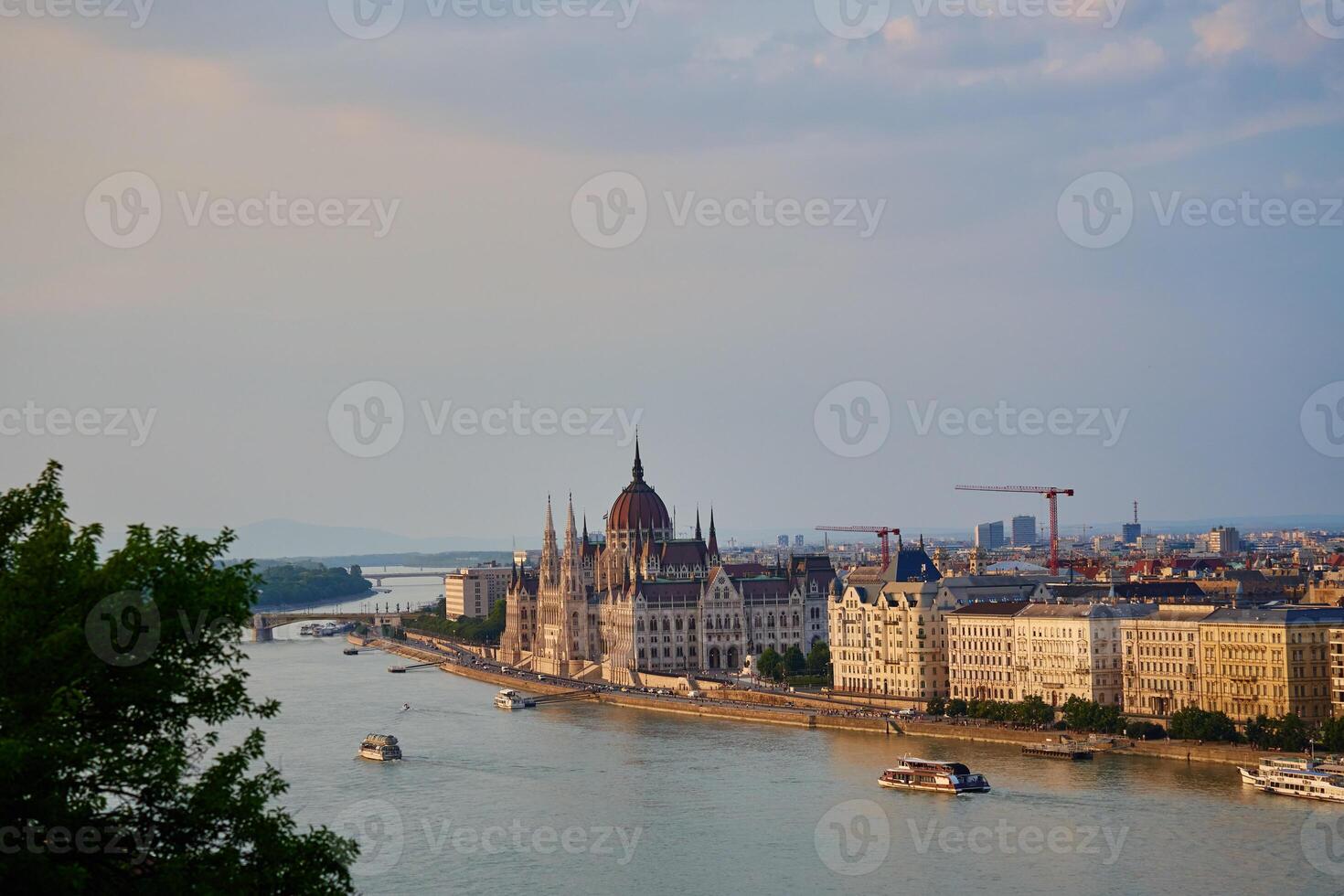 Hungarian Parliament Building in Budapest at sunset with reflection in Danube River. Neo Gothic architecture and famous landmark of Hungary photo