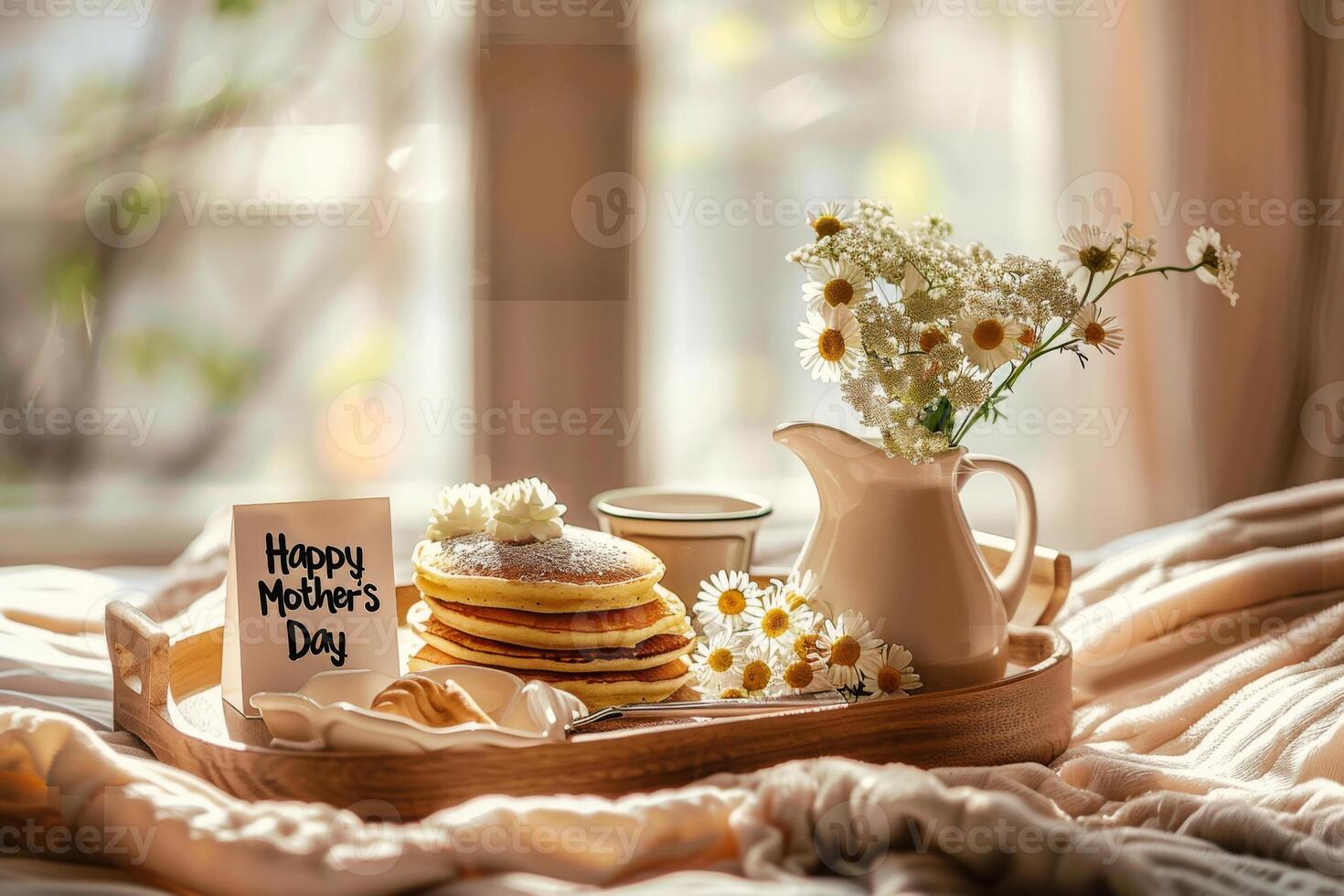 Tray with pancakes, cup of coffee and fresh flowers in bed. Cozy breakfast for Mothers Day holiday photo
