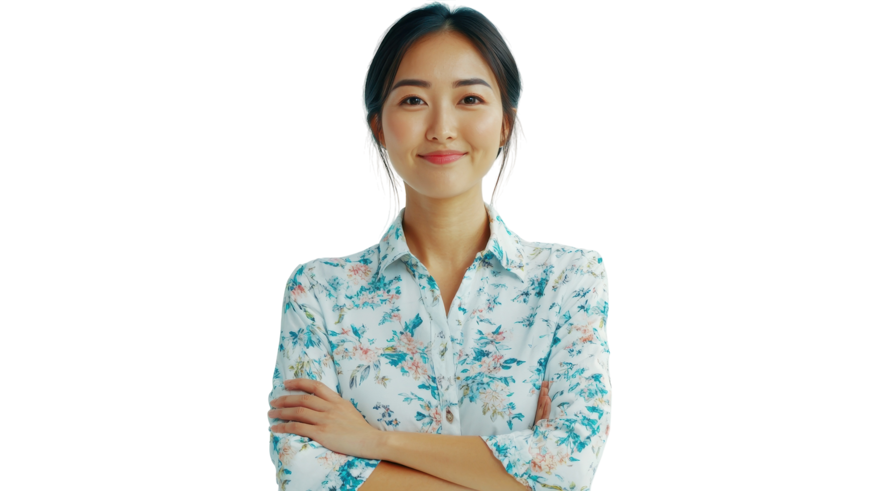 Young woman with a floral shirt smiles confidently while standing with arms crossed in a bright, white setting png