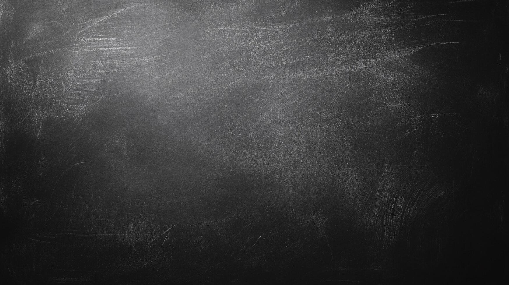 A dark chalkboard with visible chalk residue creating a textured gradient from light to dark. A great background for many different projects. photo