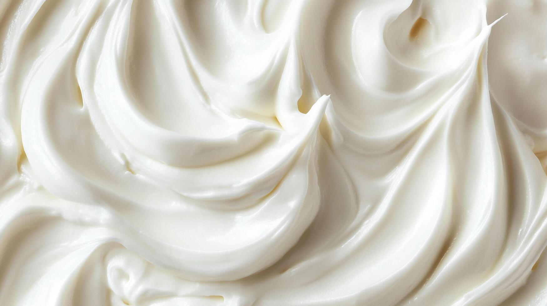A silky smooth and glossy white cream, swirled into soft peaks and valleys, reflecting light to emphasize its luxurious texture. photo