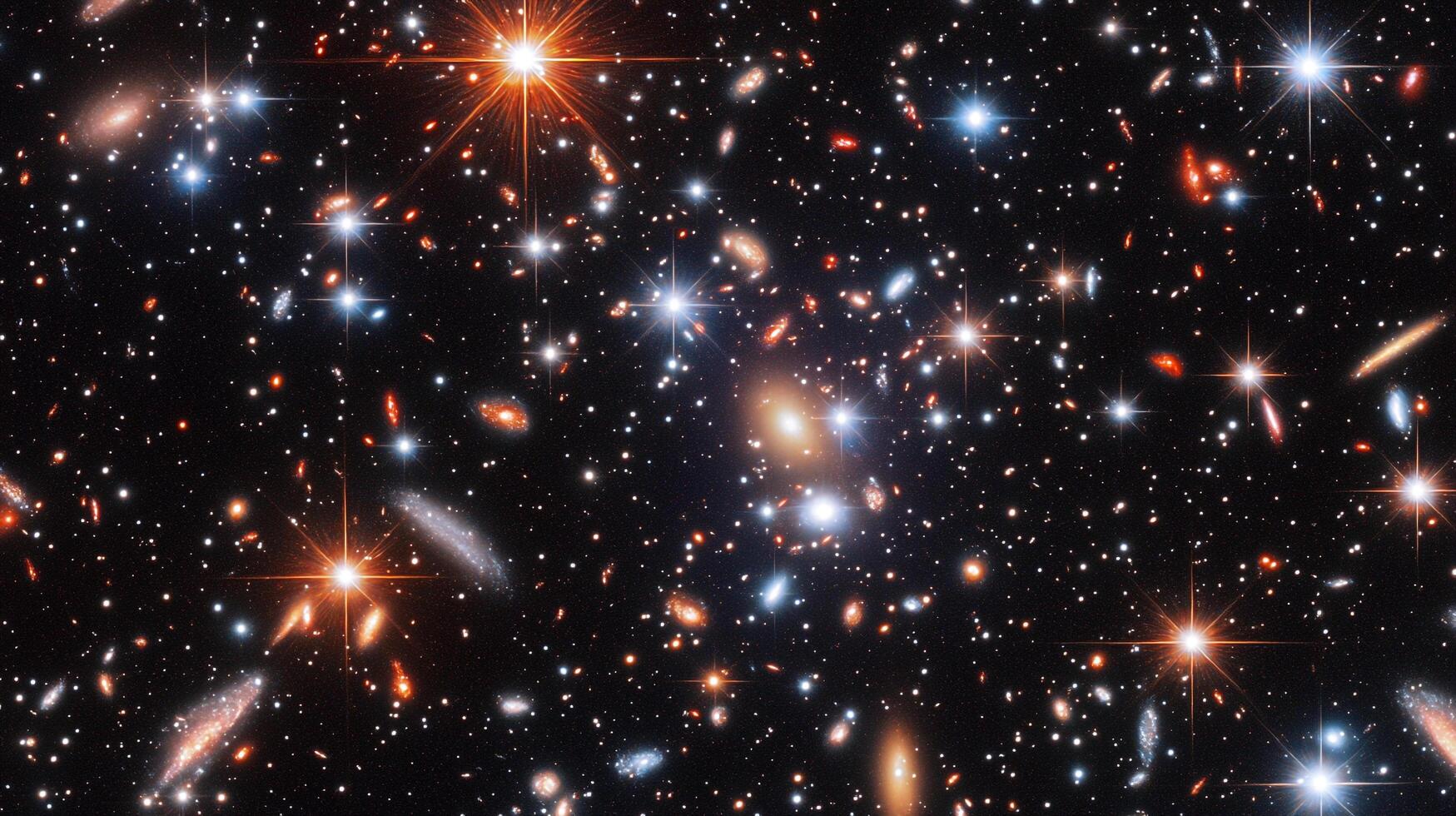 A mesmerizing view of a deep space field. Galaxies of varying shapes and colors are scattered across the dark canvas of the cosmos. photo