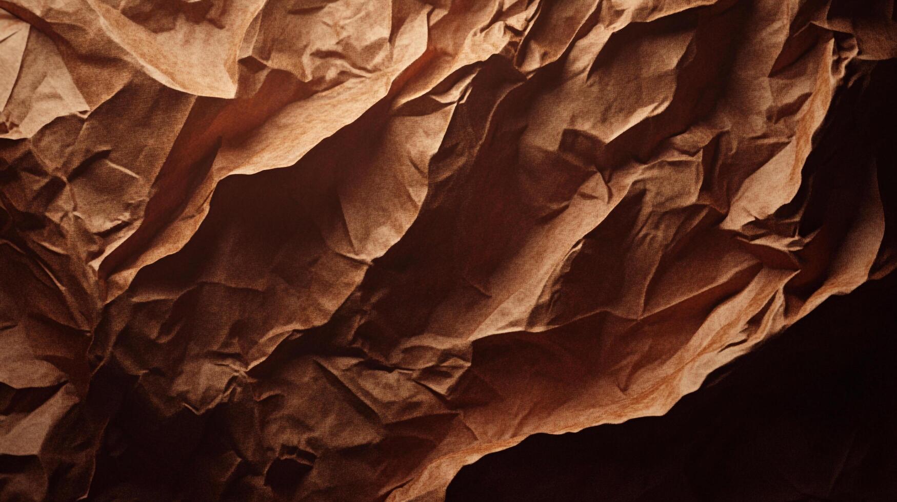 A photograph captures the interplay of light and shadow on textured fabric, creating a sense of depth and abstract art. Rich, warm brown hues. photo