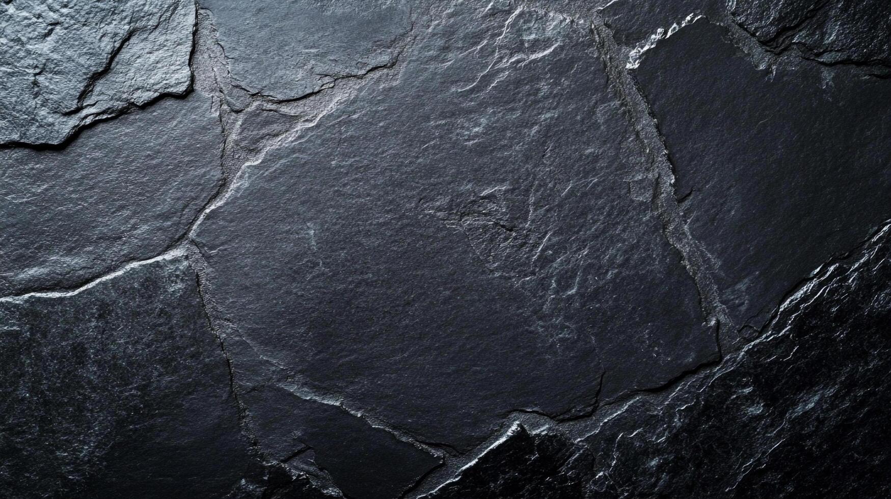 A textured surface of dark gray stone tiles, ideal for backgrounds, construction materials, and providing a touch of natural style. photo
