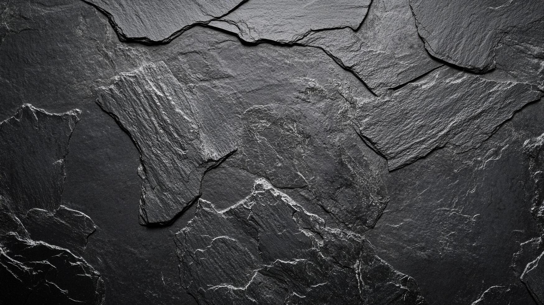 Detailed stone texture of dark grey slate, presenting a rough, layered surface with subtle highlights emphasizing rugged formations. photo