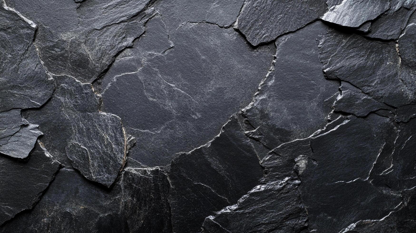 A captivating, close-up shot of rough black slate stone, displaying its intricate textures and natural patterns. Great for backgrounds and textures. photo