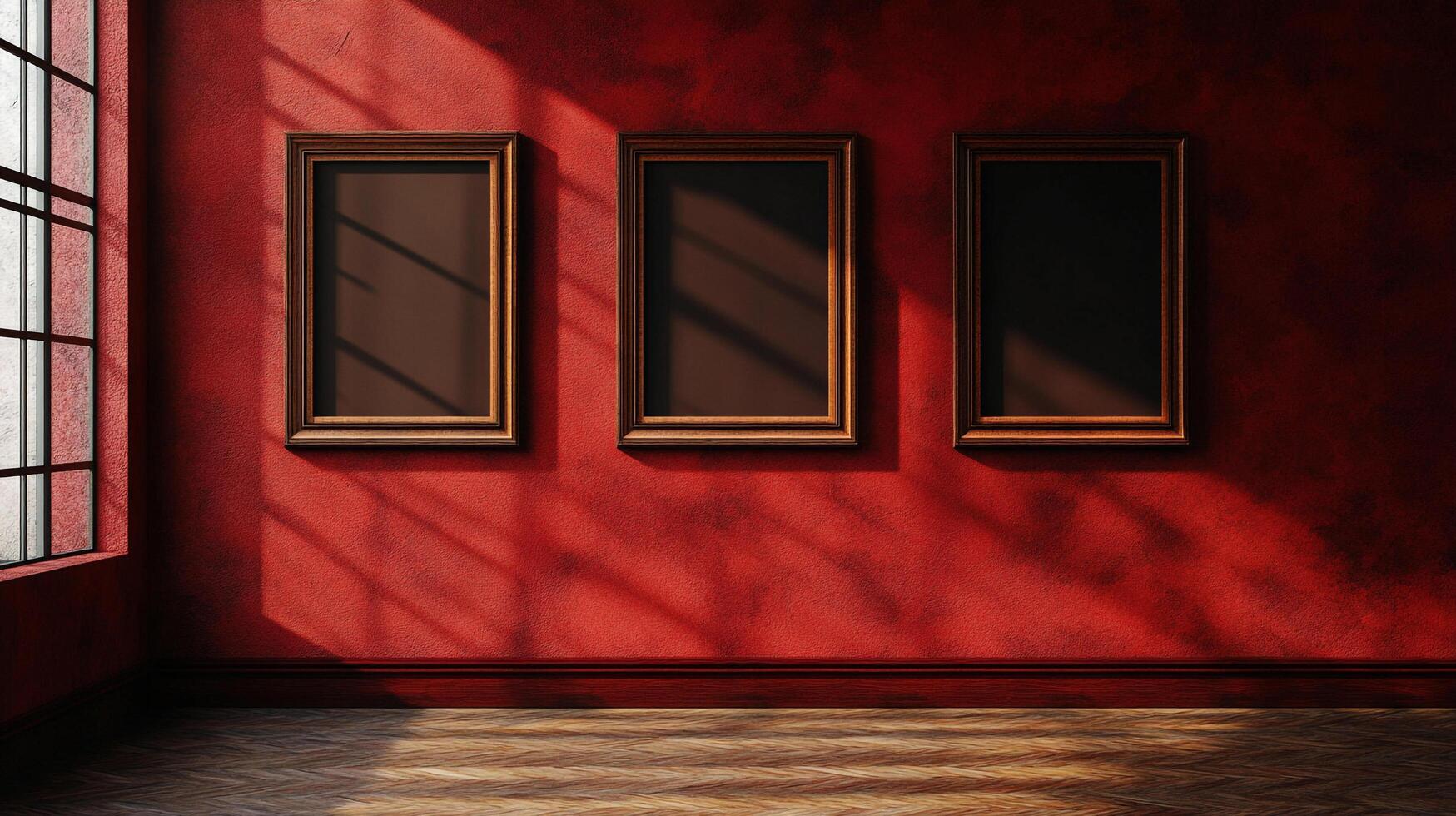 Gallery wall with three framed artworks. The red wall and herringbone floor are lit by sunlight streaming through the window. Interior space. photo