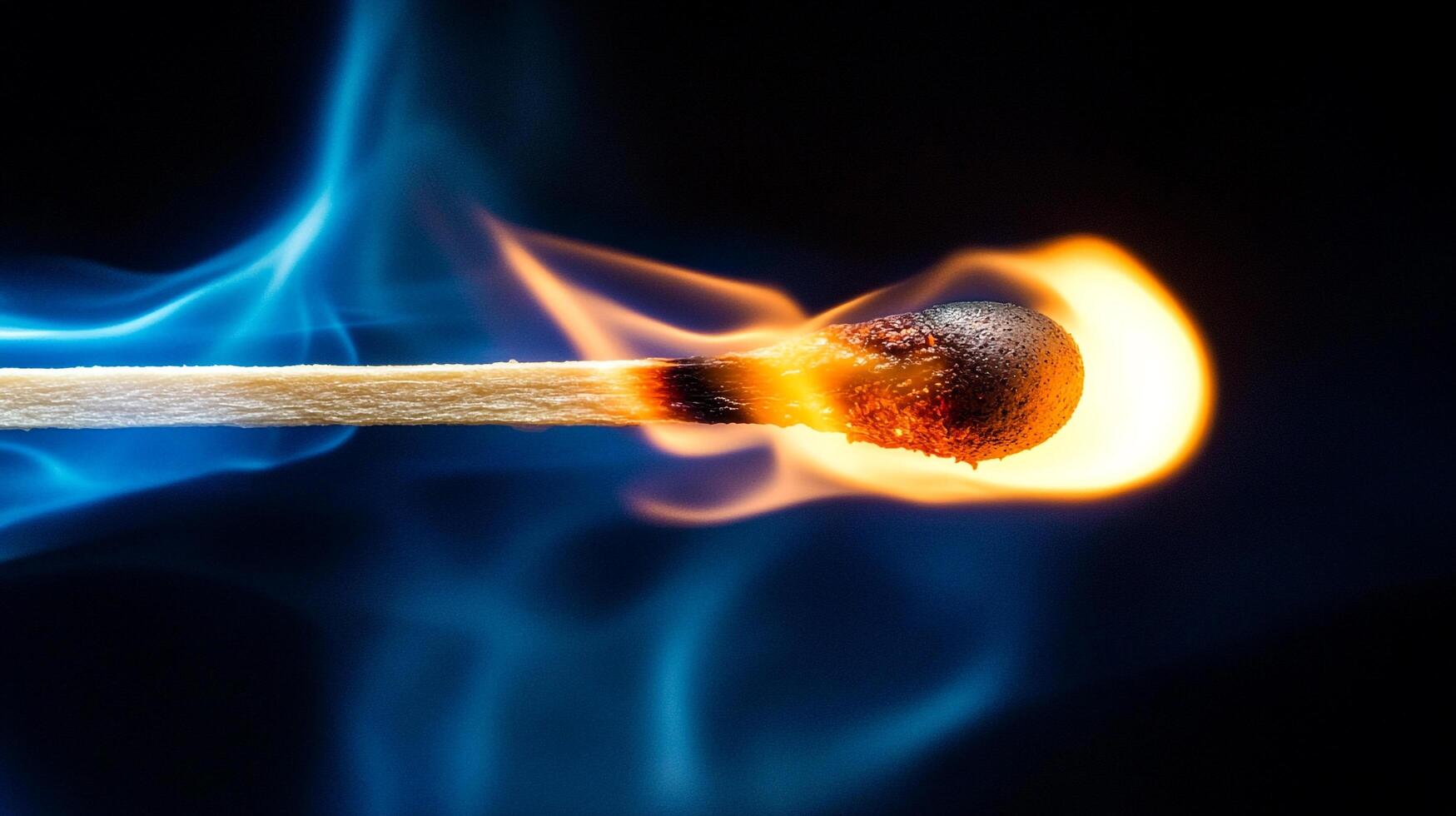 A burning match stick against a dark background, with vibrant yellow and orange flames and a blue, smoky aura. The wooden stick is lit. photo
