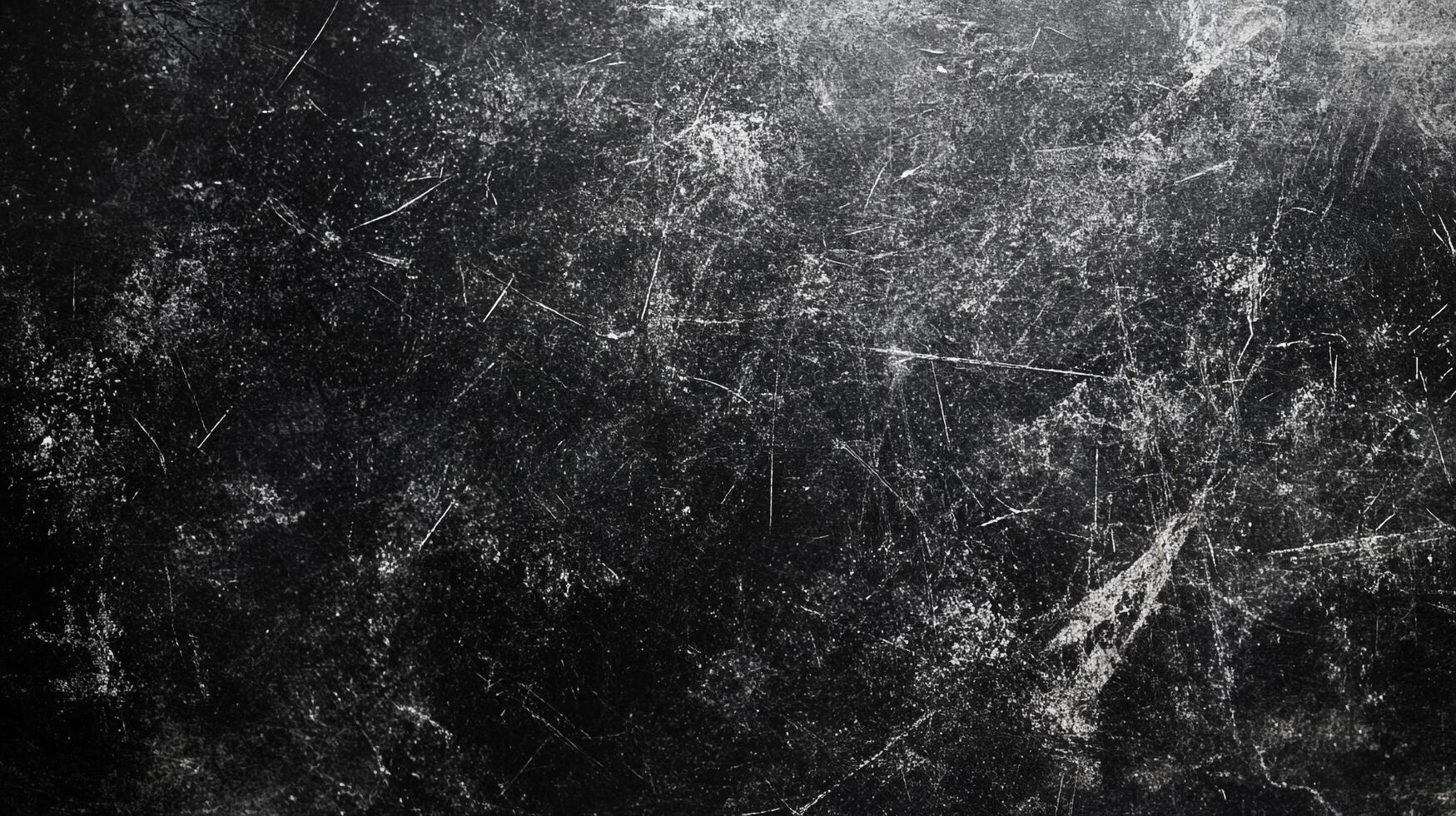 Scratched dark surface, texture, background. The rough surface shows white lines, scratches, and marks in a grunge effect. photo
