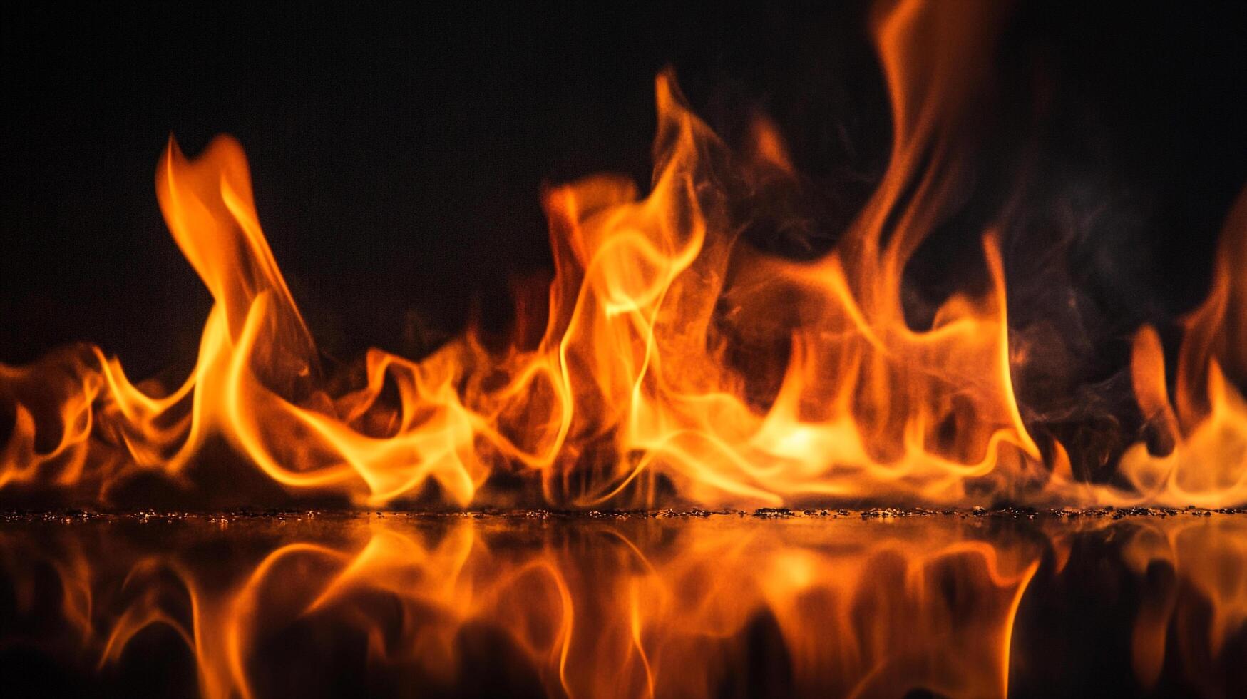 A mesmerizing dance of fire, with vibrant orange flames against a dark backdrop, mirrored in a sleek surface below, creating a captivating scene. photo