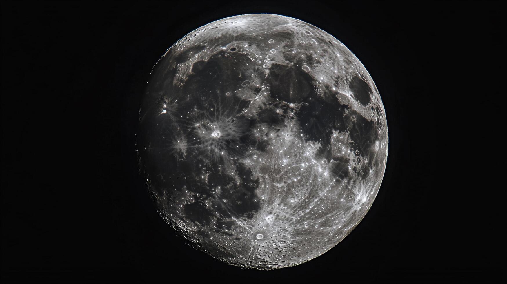 Detailed lunar surface showcasing craters, maria, and highlands against the dark expanse of space, captured in striking astronomical detail. photo