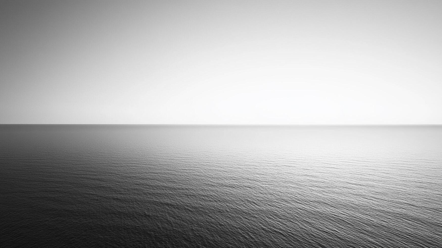 This elegant monochrome image presents a minimalist ocean view where the calm waters meet the horizon, creating a sense of tranquility and infinite possibilities. photo