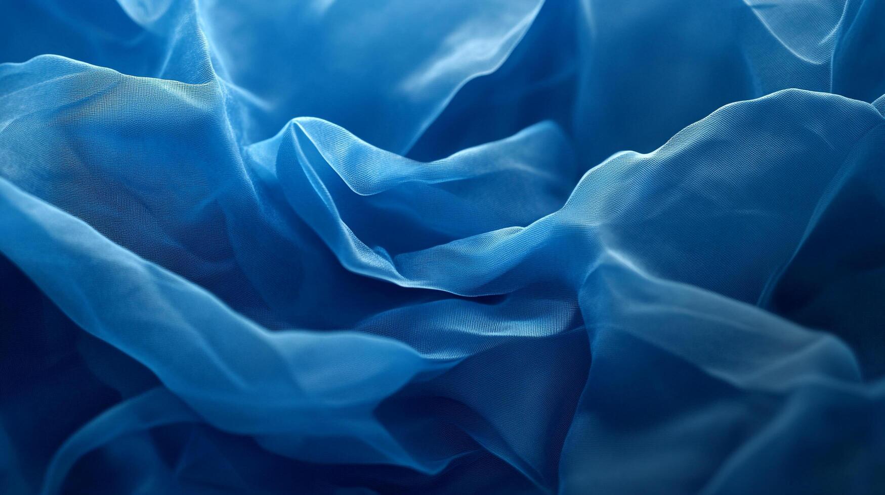 This image showcases a delicate blue fabric with soft textures and flowing folds, creating an elegant and calming visual effect that invites the viewer to explore. photo
