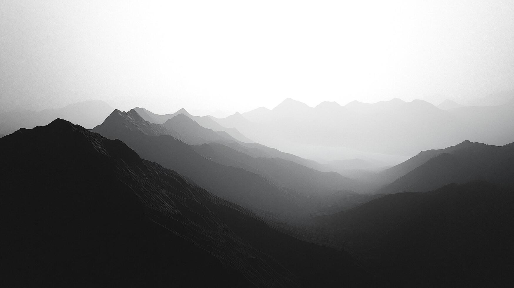 A monochromatic view of mountains enveloped in fog, illustrating a sense of mystery and depth that captivates the observer, conveying emotions of solitude and contemplation. photo