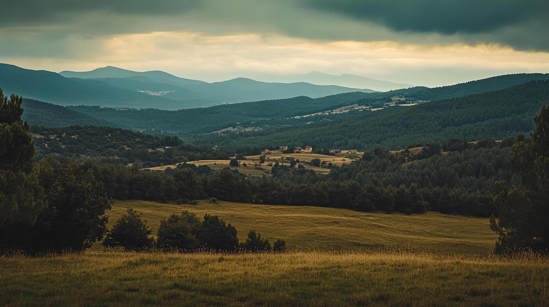 Scenic view of rolling hills and mountains under a cloudy sky, showcasing the beauty of nature in a tranquil, rural landscape. photo