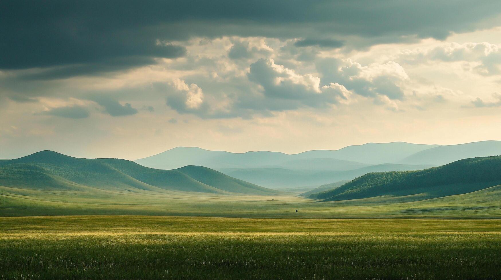 Sweeping hills and plains under a dramatic sky create a tranquil landscape, hinting at nature's untouched beauty and serene vastness. photo