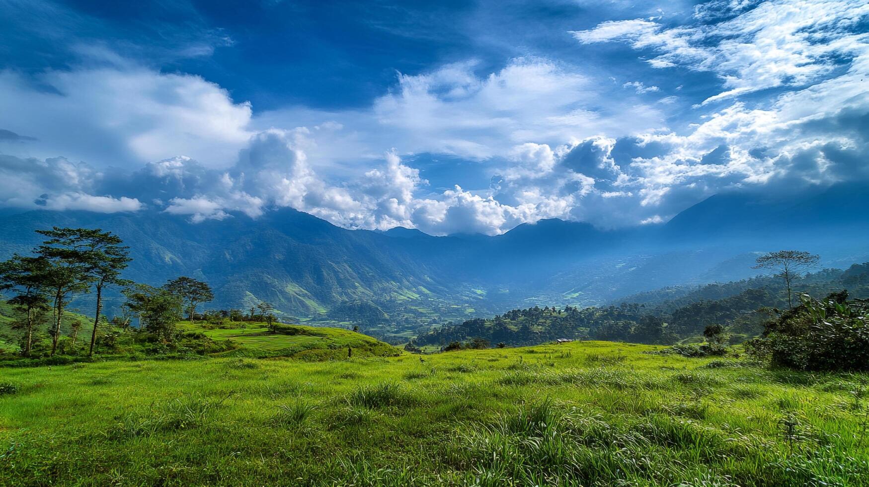 Lush green landscape featuring rolling hills, verdant meadows, distant mountains, and a sky filled with puffy white clouds. photo