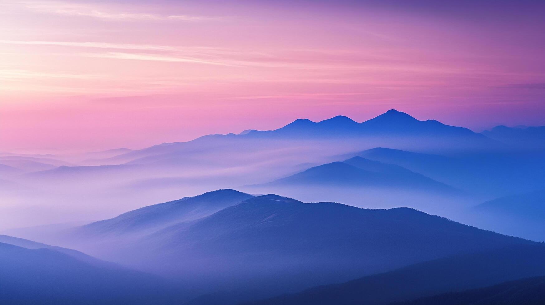 A beautiful mountain range with misty valleys is painted with the colorful hues of a vibrant sunset, creating a tranquil, serene vista. photo