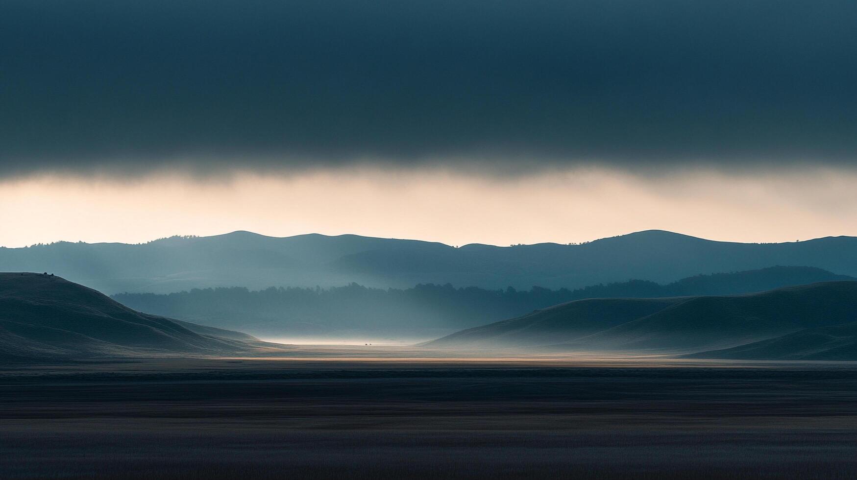 Misty valley beneath a brooding sky, layers of hills fading into the horizon, creating a tranquil landscape. Nature's grand vista. photo