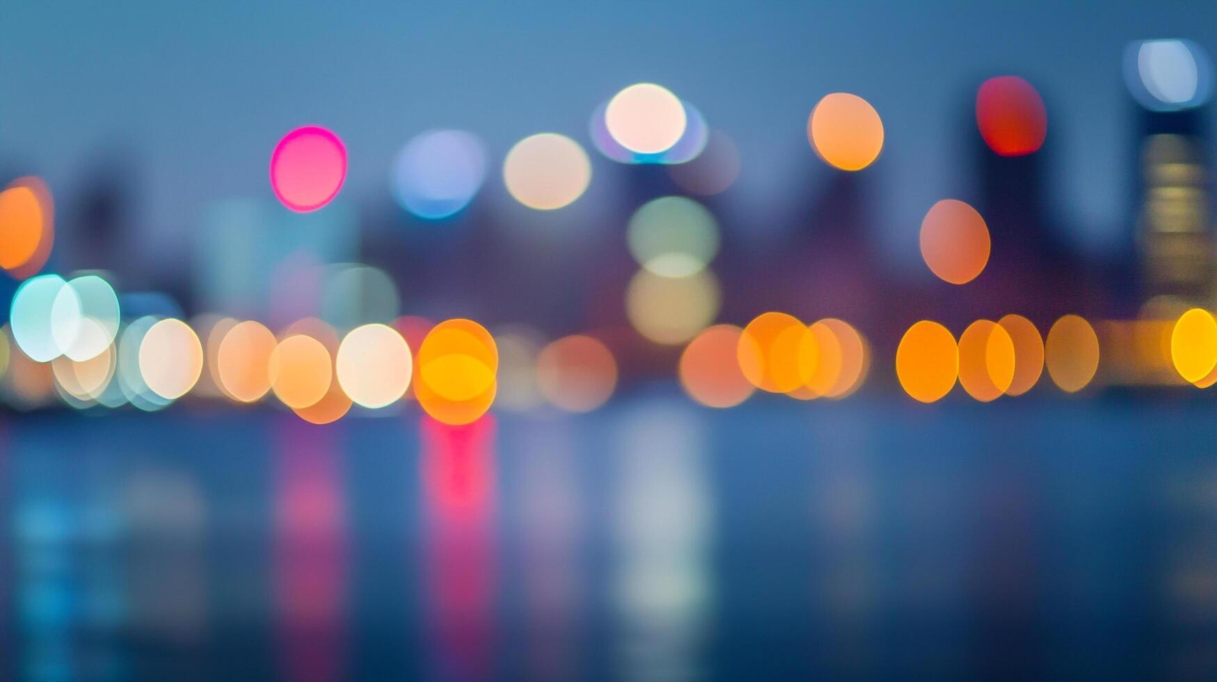 Defocused city lights illuminate the night skyline, reflecting shimmering colors on water. A captivating urban scene, blurred yet beautiful. photo