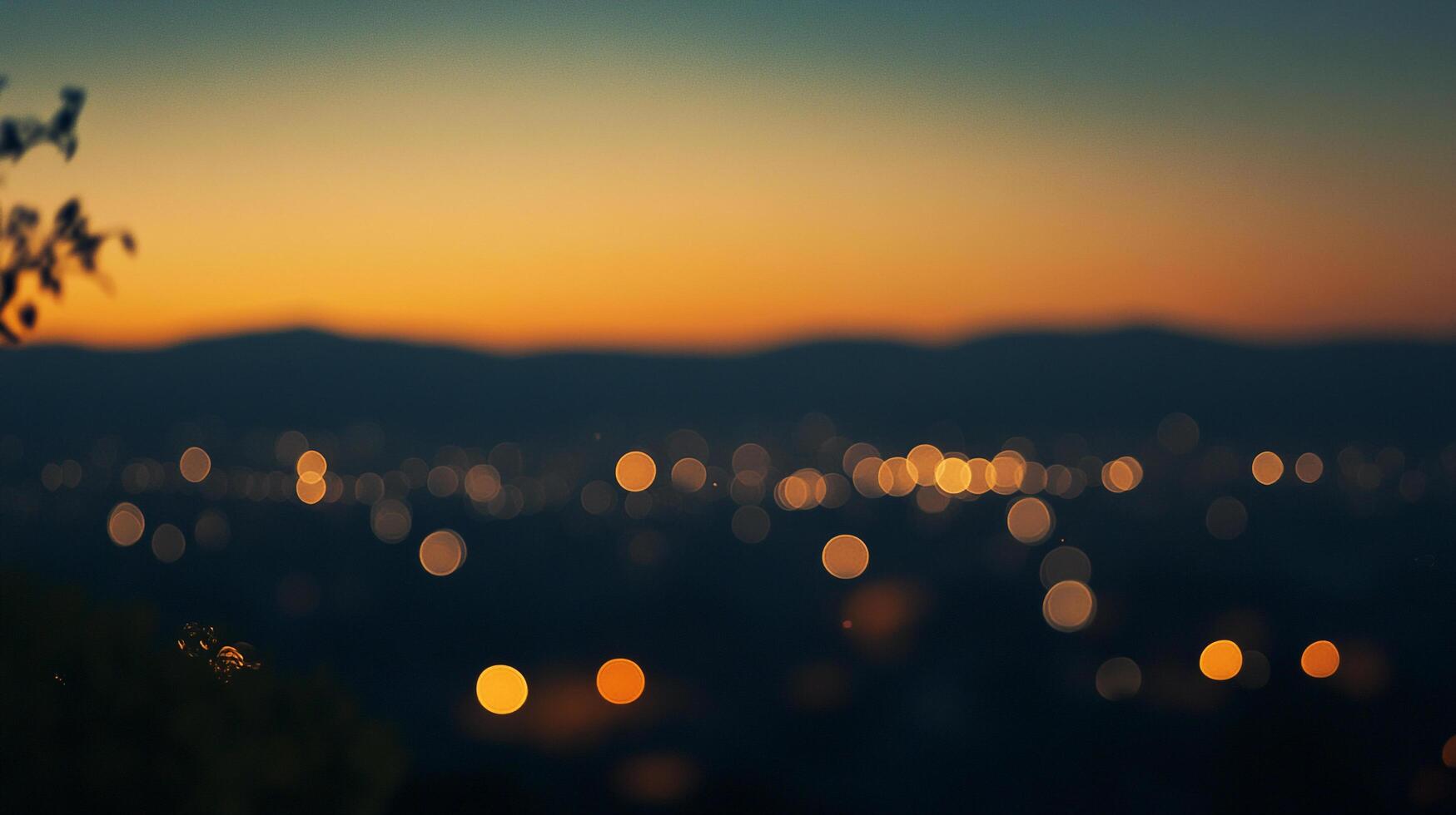 Blurred city lights shine beneath a vibrant twilight sky, casting a dreamy glow over the distant mountain range. Quiet beauty unfolds. photo