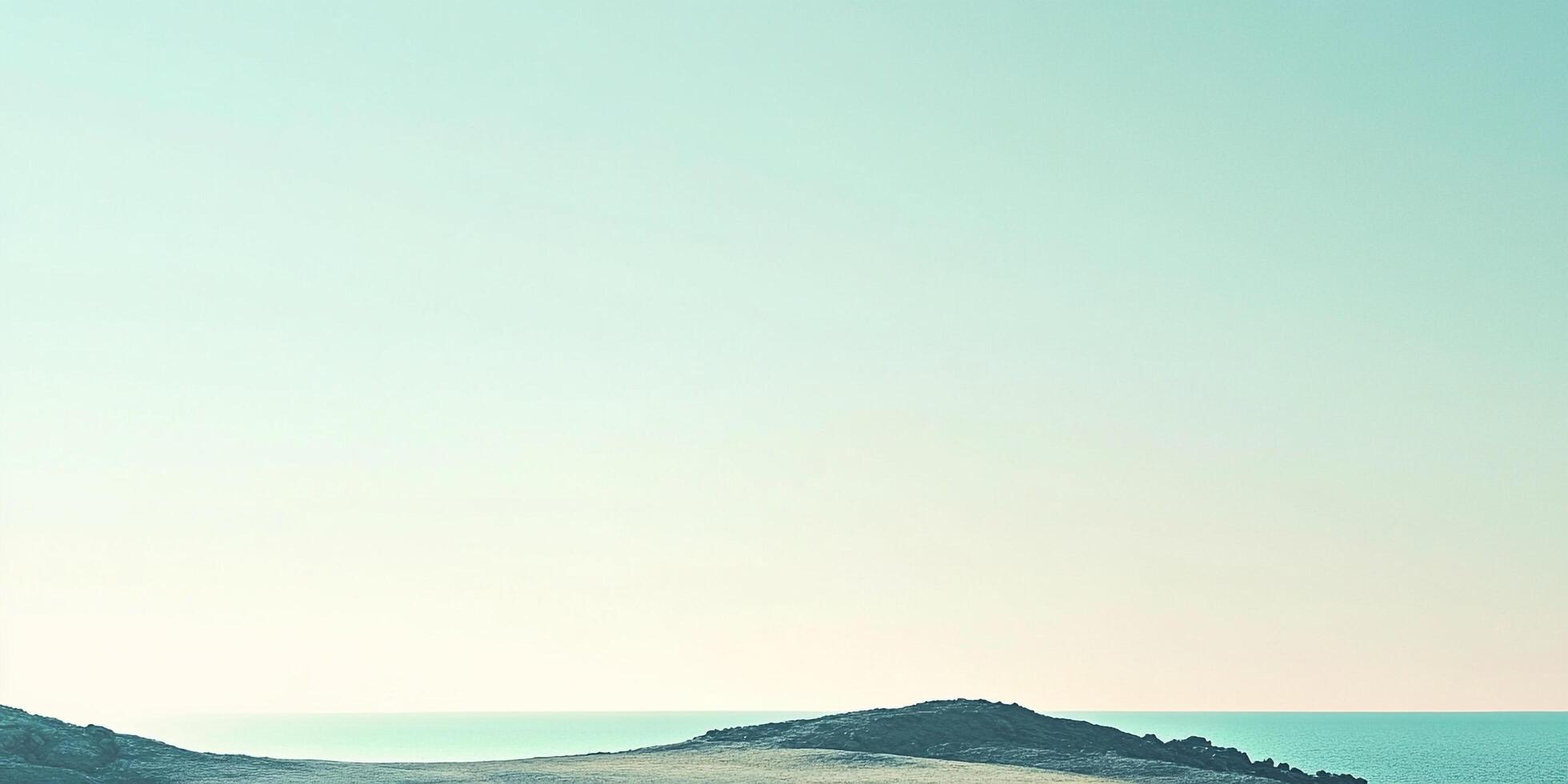 Minimalist beach scene with a tranquil sea and landmass against a soft, gradient sky. Calm, serene, and minimalistic seascape. photo
