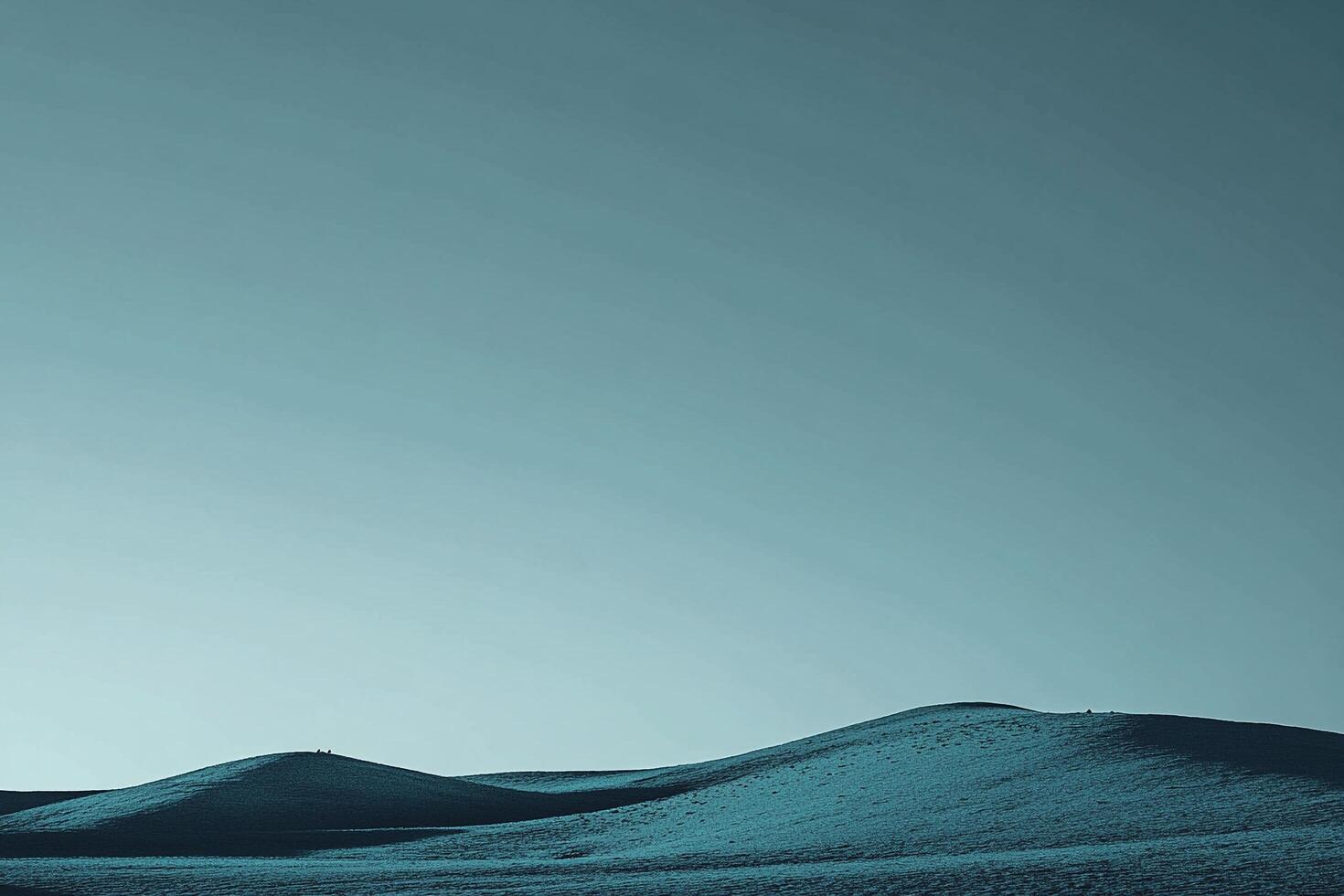 Expansive, serene rolling hills and calming blue sky creating a peaceful scene. Landscape photography evoking tranquility, simple beauty photo