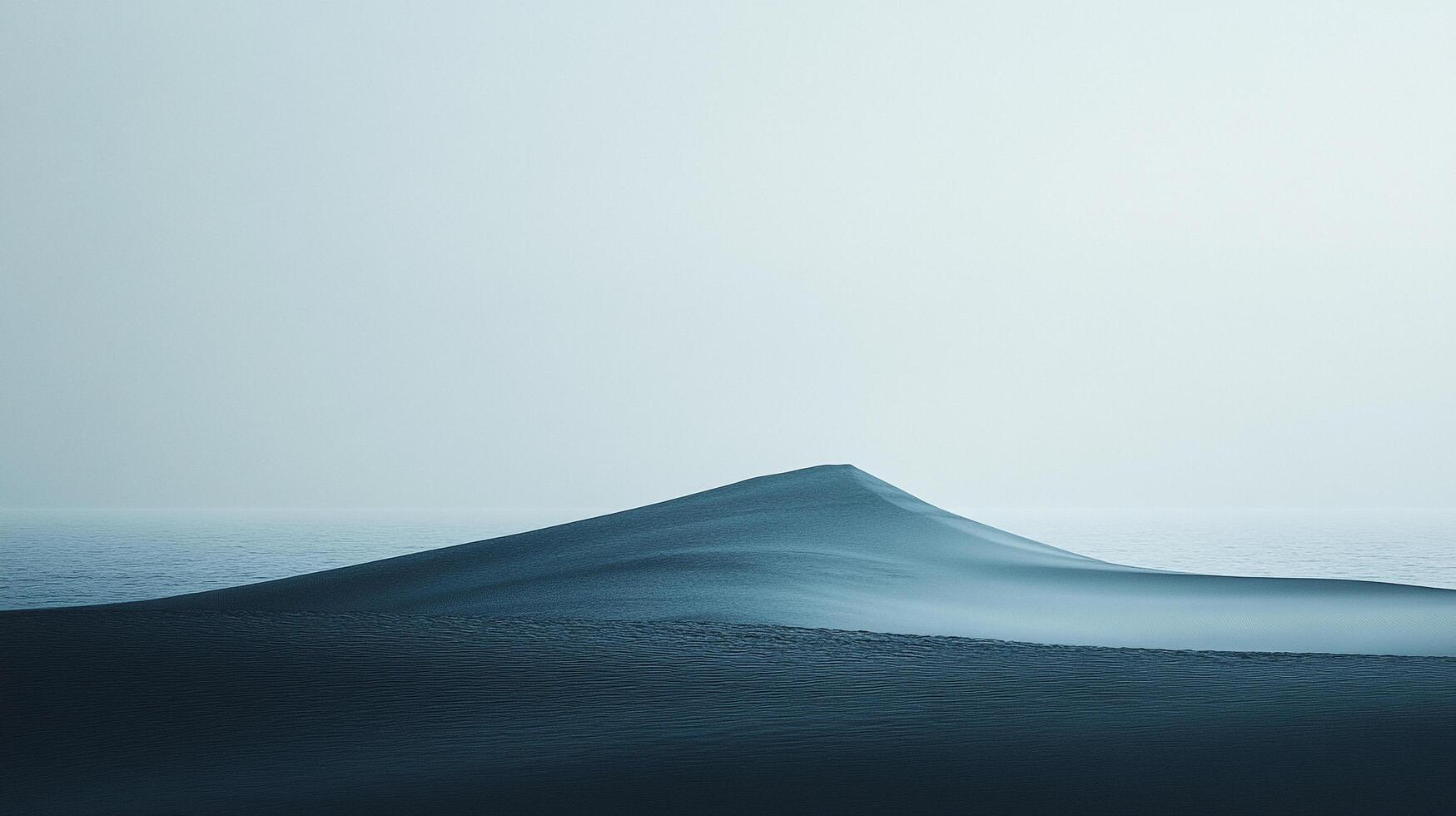 An ethereal landscape of subtle gradients reveals a sand dune gently sloping to meet the serene expanse of a misty ocean horizon. photo