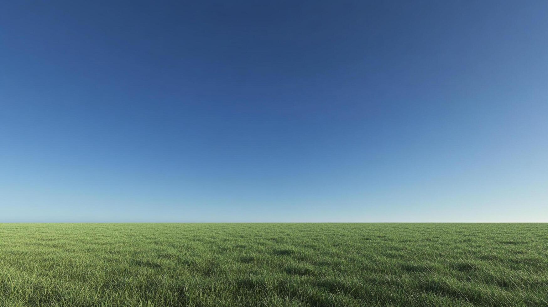Expansive green field under a clear blue sky, offering a tranquil and open landscape view. Serene nature scene for backgrounds or imagery. photo