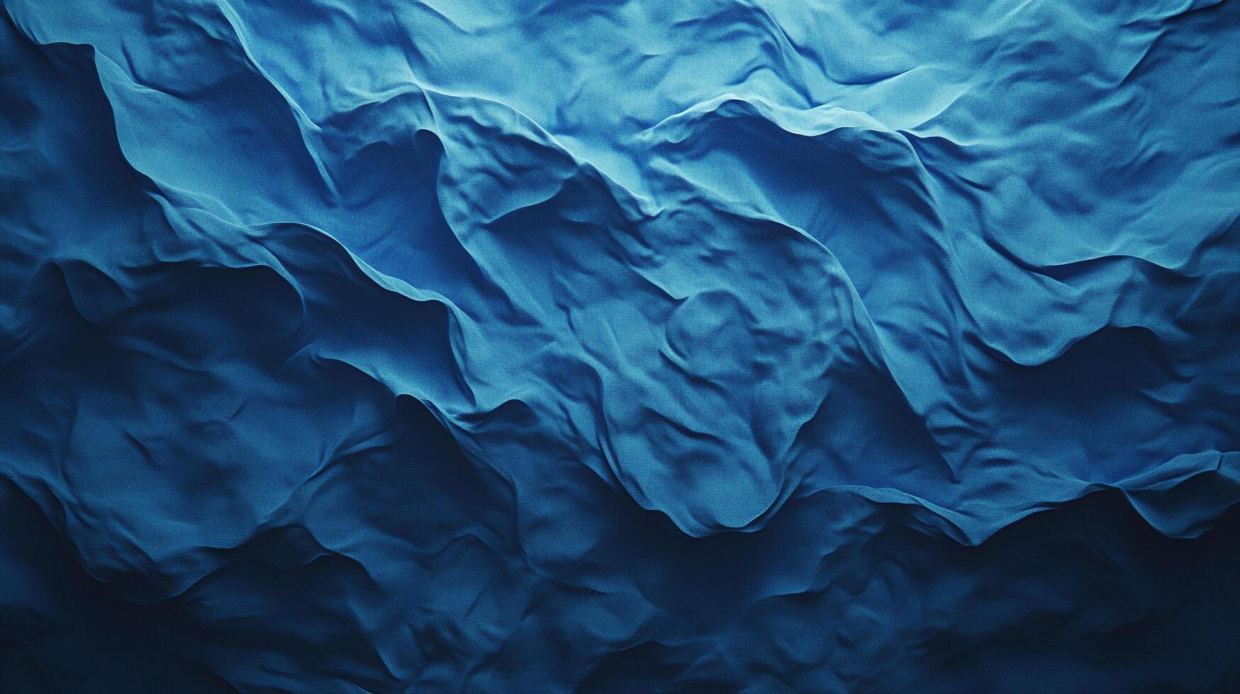 Abstract image of flowing deep blue fabric, folds, and textures creating a dynamic visual experience. Darker shades offer depth and contrast. photo