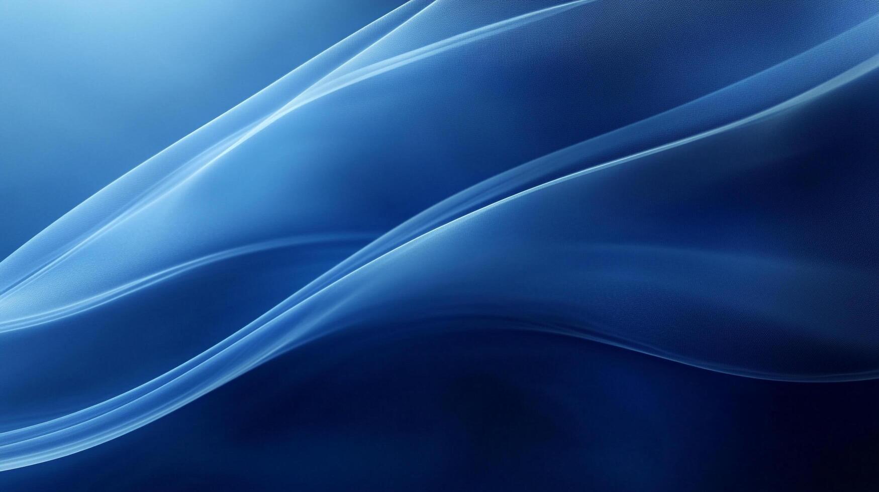Elegant abstract blue waves flow smoothly across the frame, creating a dynamic sense of movement and depth in cool tones and soft light. photo