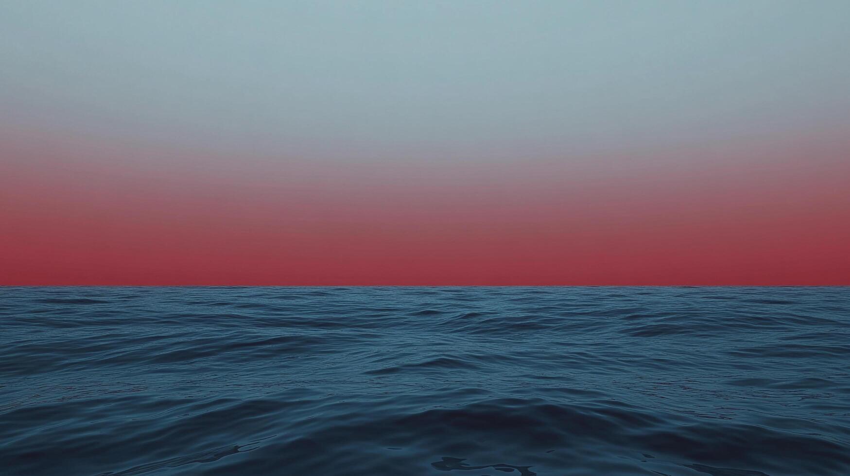 Serene seascape at dusk, featuring tranquil blue water gently rippling under a gradient sky shifting from red to soft blue, a peaceful horizon. photo