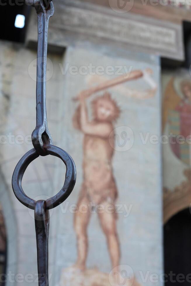 A large metal chain with a painting of a man on it photo