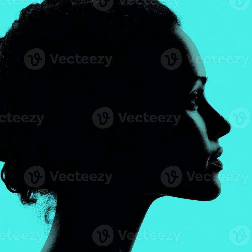 Woman silhouette profile on teal backdrop photo