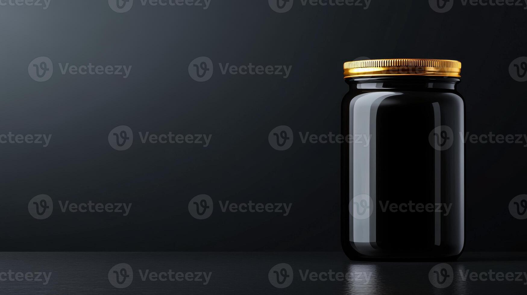 Jar of black substance with golden lid on dark surface photo