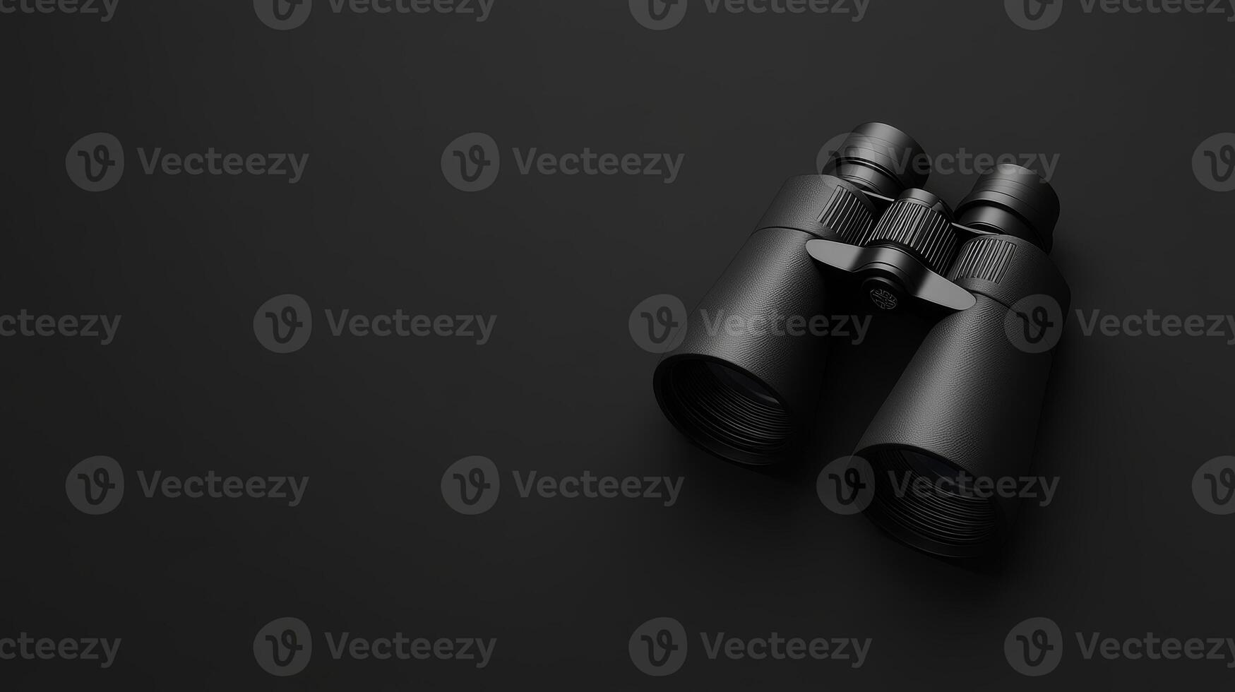 Binoculars resting on a sleek black surface for exploration photo