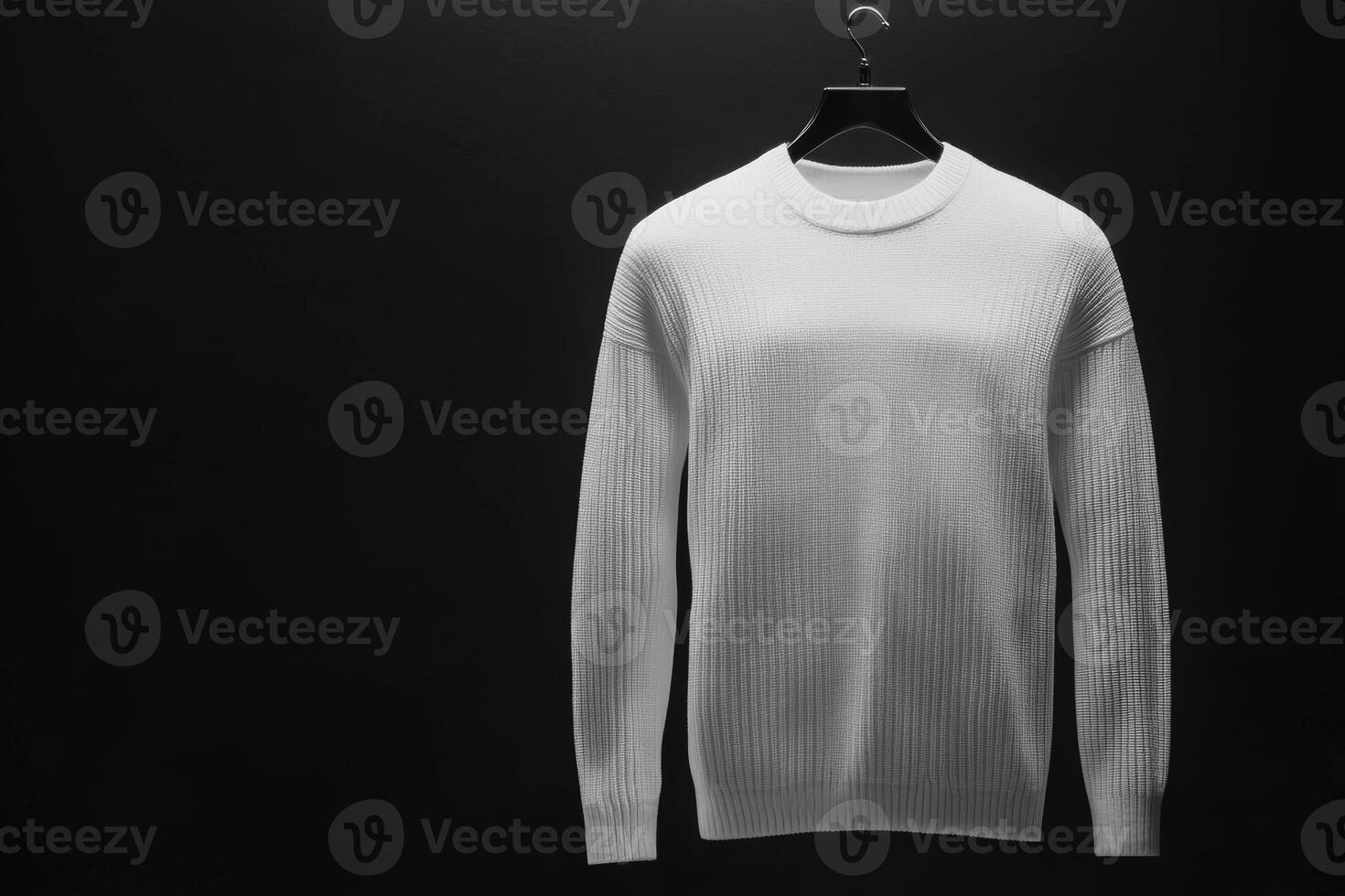Elegant white sweater displayed against a dark backdrop photo