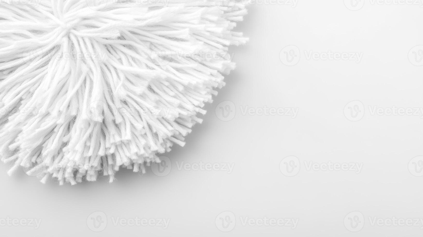 Soft white mop head resting on a clean surface for cleaning tasks photo