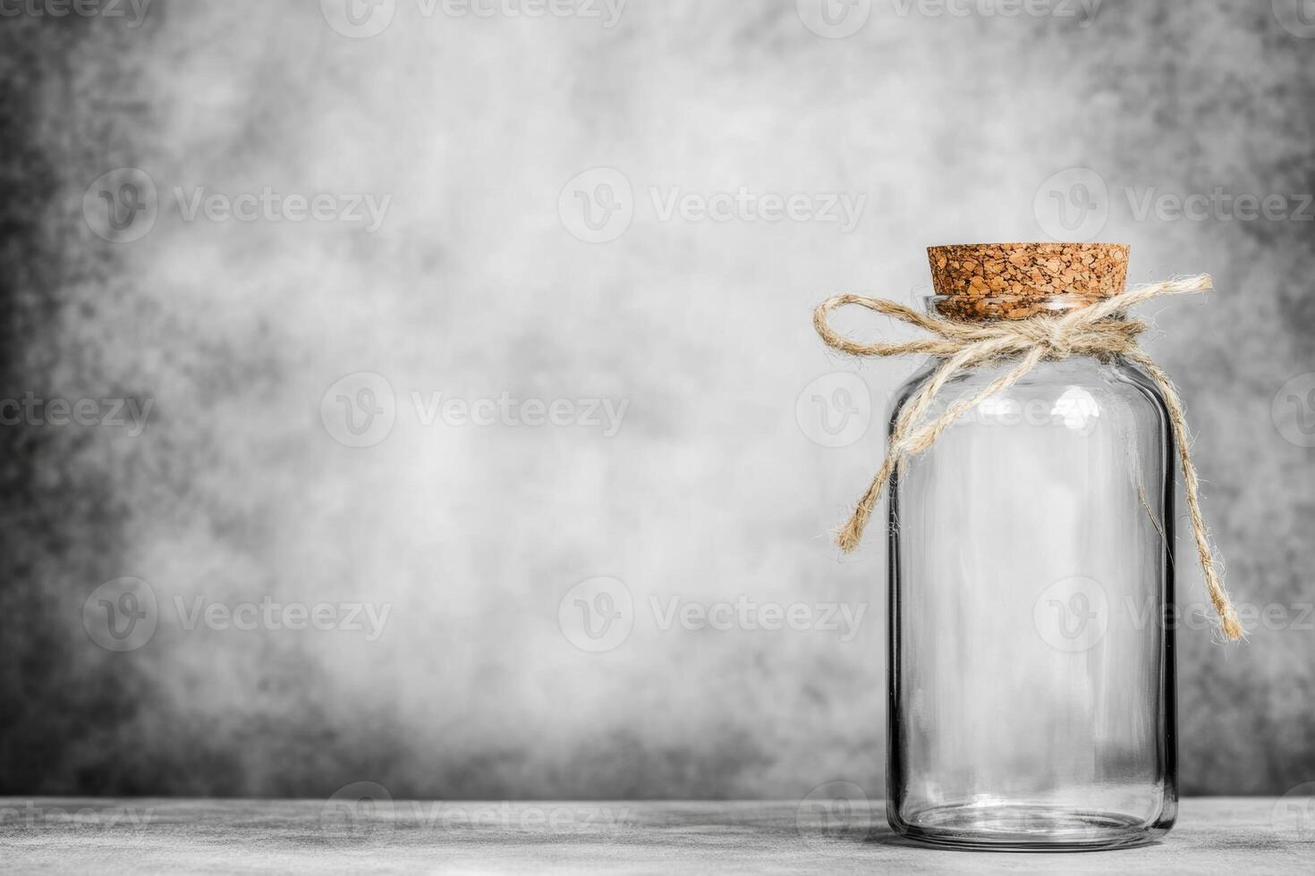 Glass jar with cork lid and twine on neutral background photo