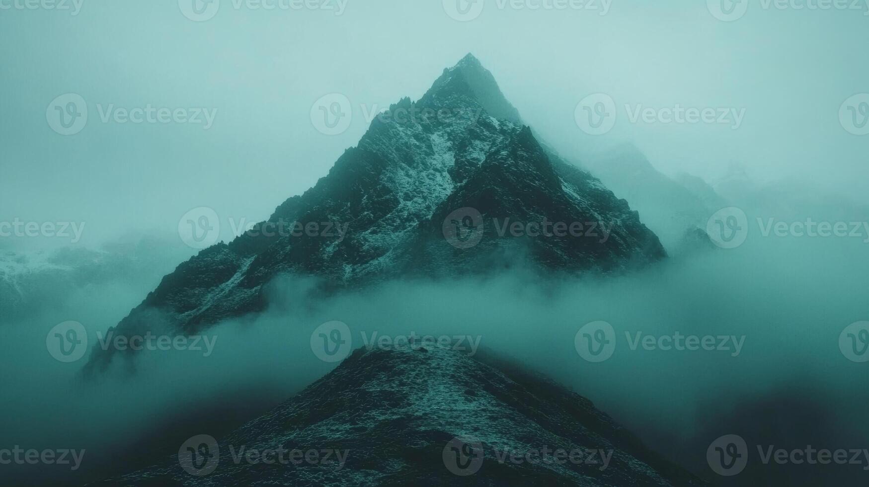 Majestic mountain peak enveloped in mysterious misty fog photo