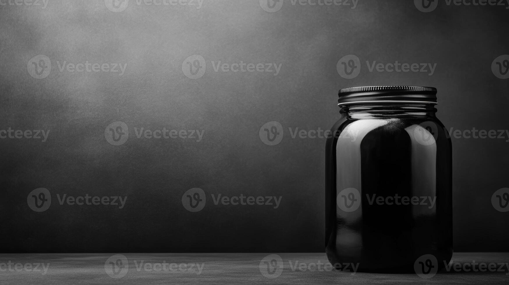 Black jar sits alone on a dark surface creating a moody atmosphere photo