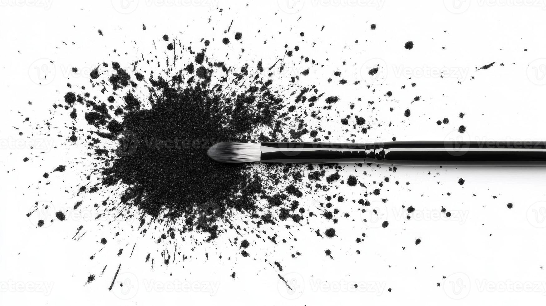 Black makeup powder scattered around a brush on white surface photo