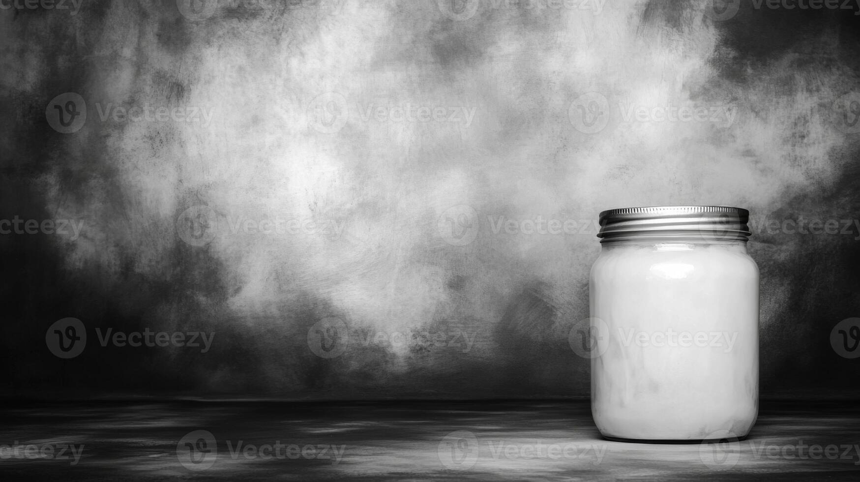 Simple glass jar on a textured background with subtle contrasts photo