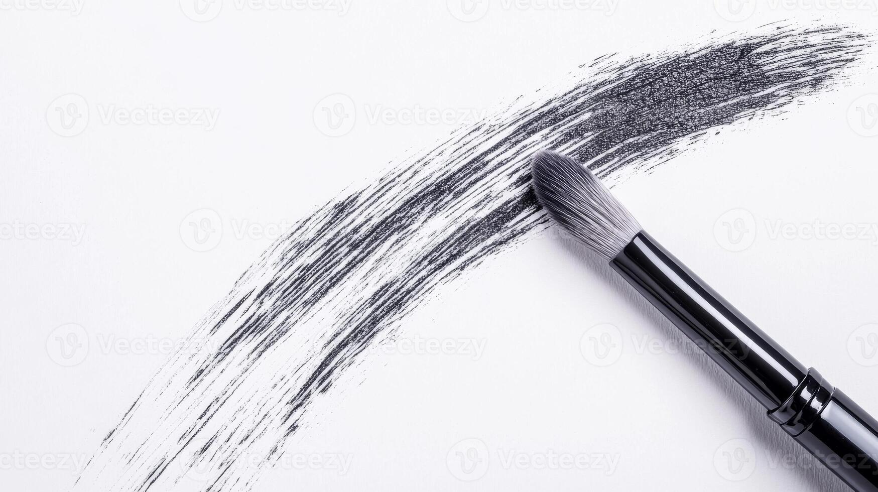 Brush creating a stroke on white paper surface photo