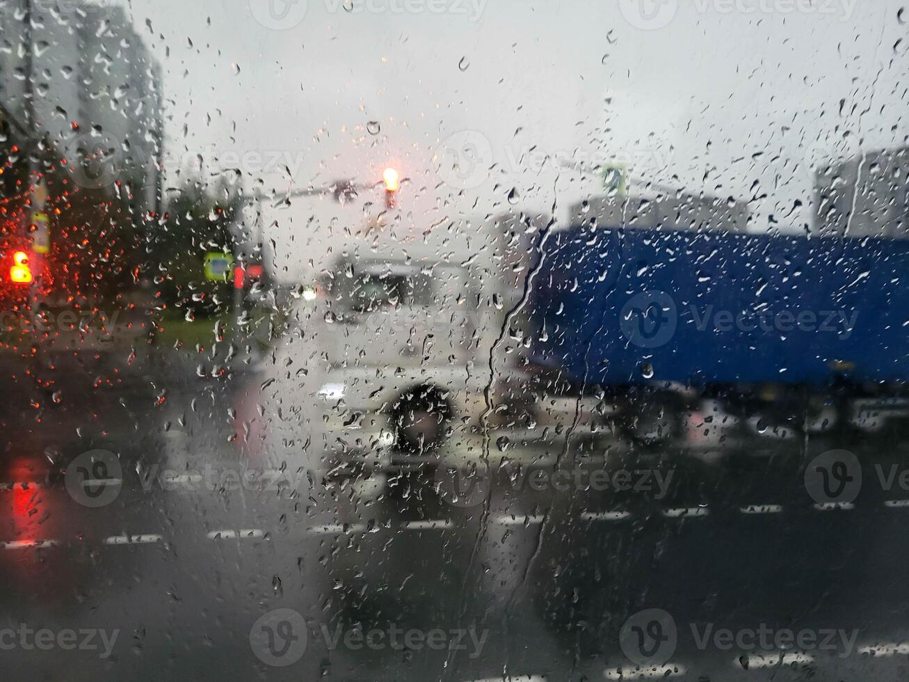 Rainy weather in the city, view through the glass of the bus photo