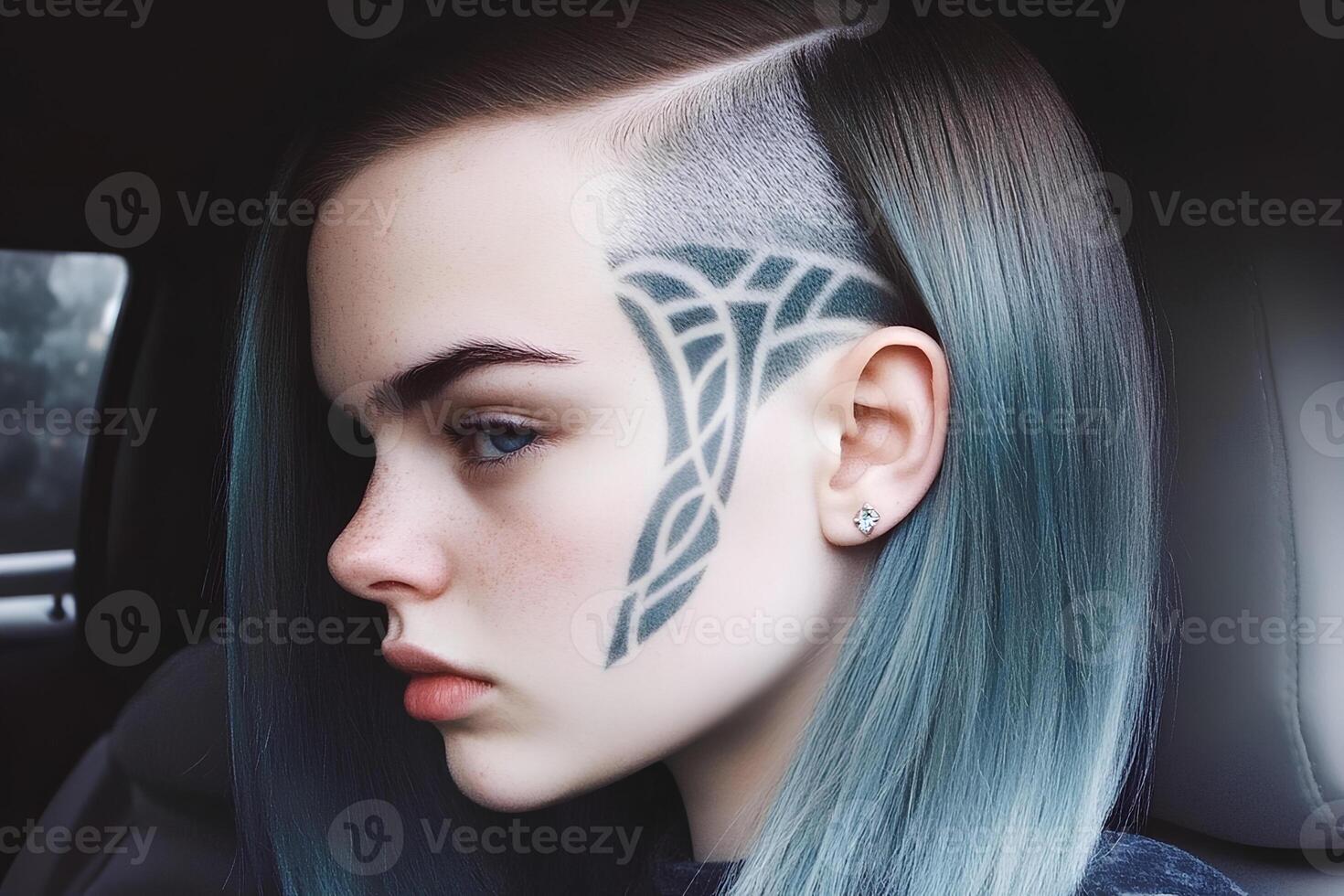 A stunning young woman with vibrant blue hair and a unique tattoo on her face, sitting in the driver's seat of a car, exuding confidence and style photo