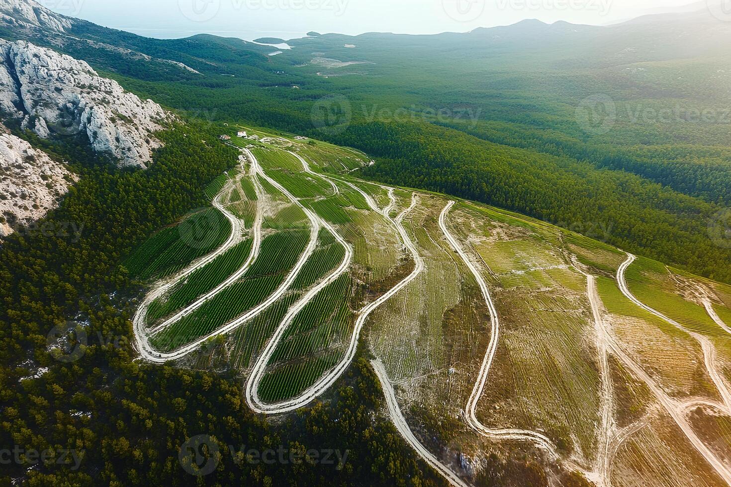 A breathtaking aerial shot of a winding road through rugged mountain terrain, captured with drone photography showcasing the beauty of nature photo